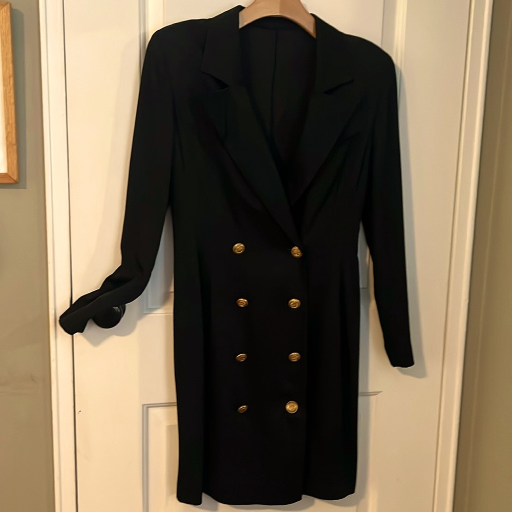 Black jacket dress with brass buttons.
